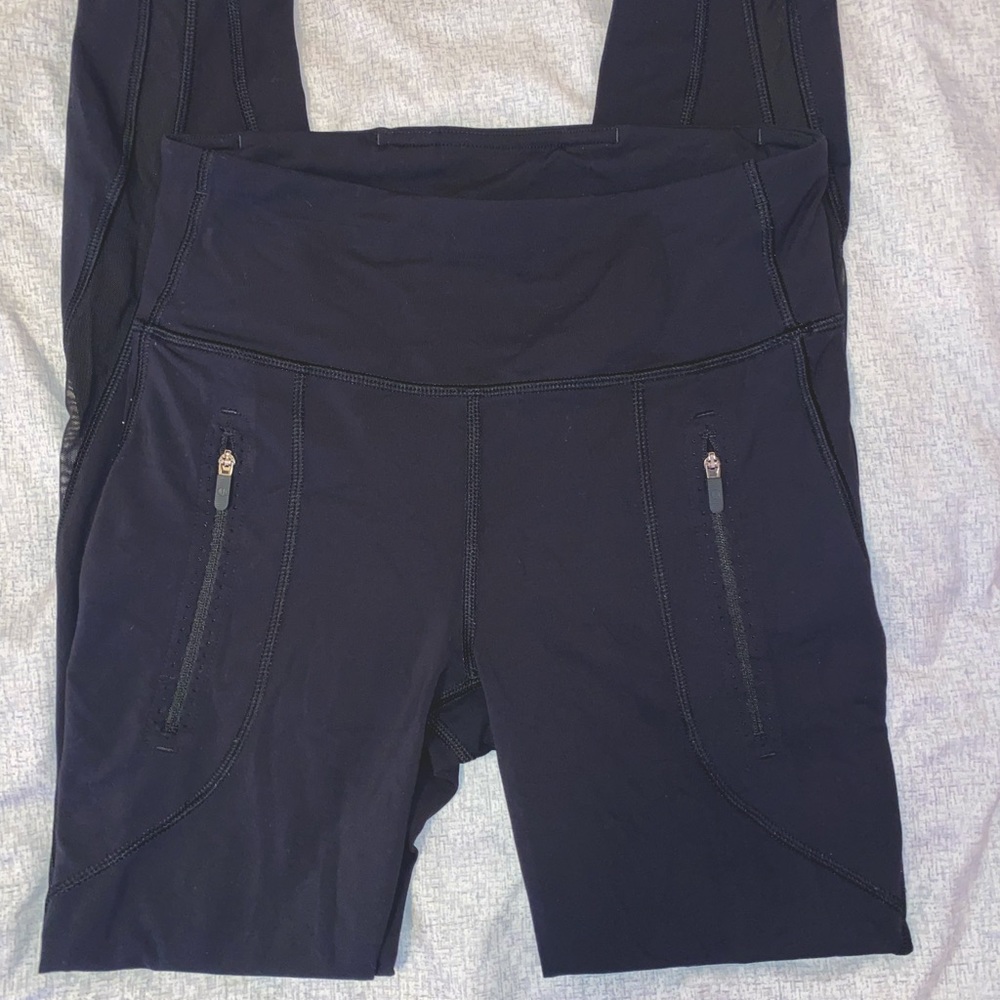 Black Lululemon leggings with mesh lining going down the leg